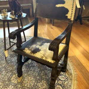 Carved oak armchair with original cowhide seats and back and stud detail on a peg construction base Spain circa 1940 (another available)